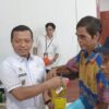 Bupati Pringsewu  Riyanto Serahkan Bantuan Pangan Beras dan Minyak Kepada Masyarakat Pekon Rejosari